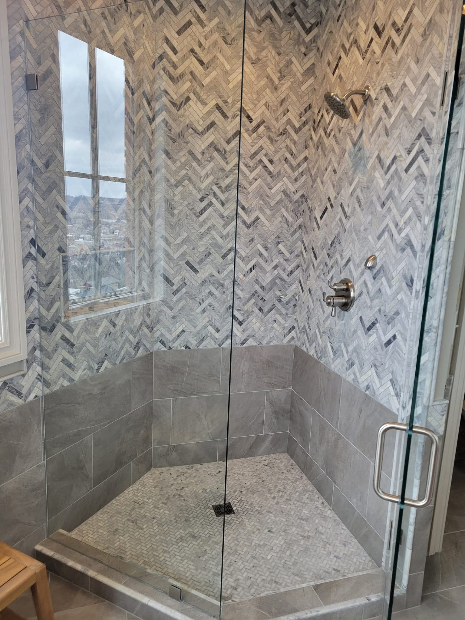 Herringbone marble shower remodel with skyline view, McGuire Plumbing