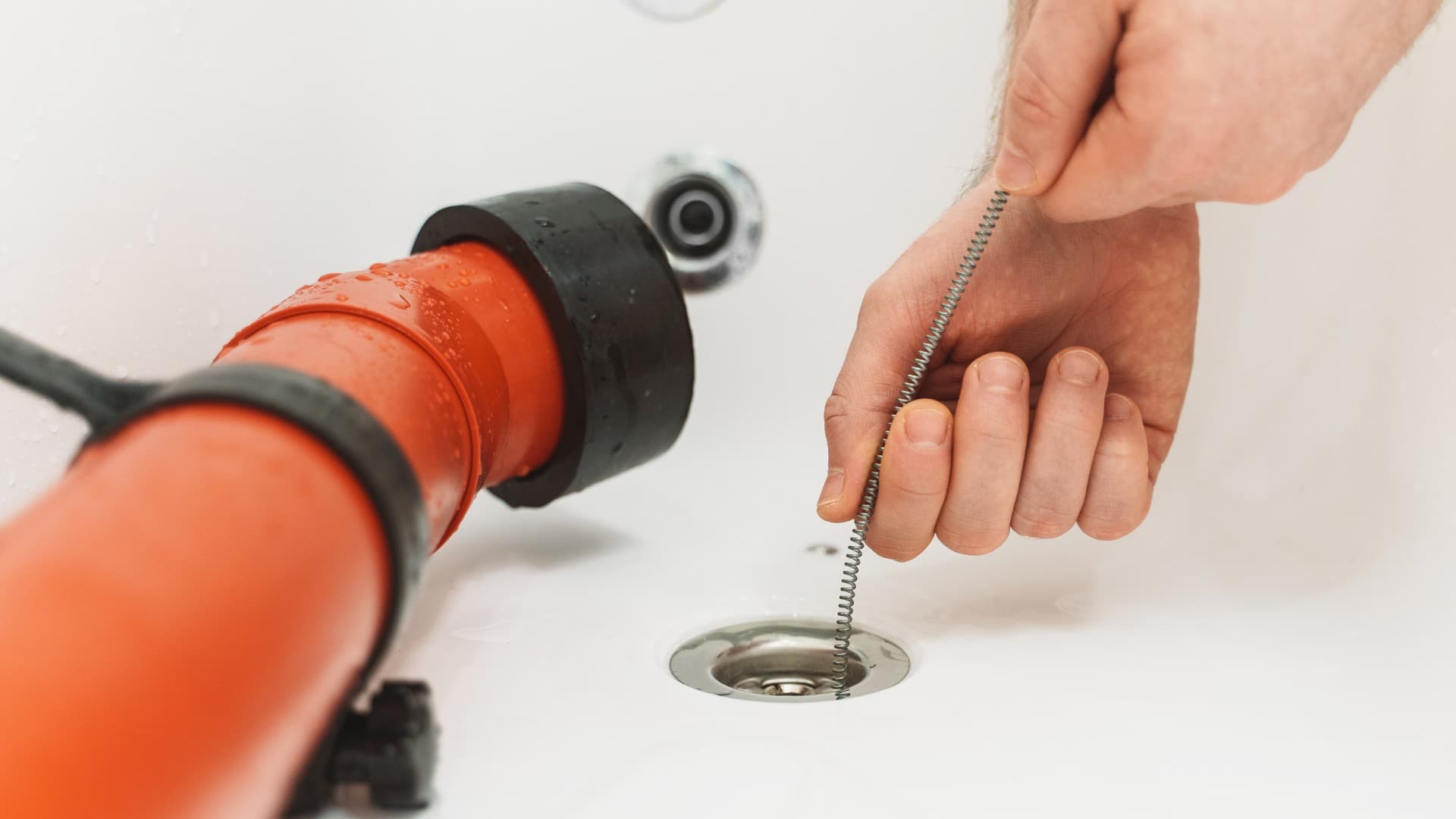 Drain cleaning with a plumbing snake